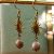Boucles pierre de soleil et pendentif soleil doré